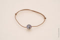 Bracelet perle cerclée sur cordon