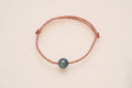 Bracelet perle ovale sur cordon doré - cuivré