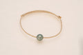 Bracelet perle ovale sur cordon doré – doré