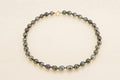 Collier de perles cerclées fermoir or